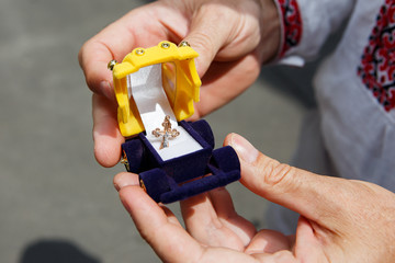 Fototapeta premium cross for a baptism in a box in the form of the car