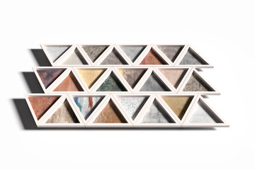 Wall with triangles of different materials in white frames