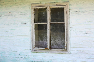 Fototapeta na wymiar Boarded Window of an Abandoned White House