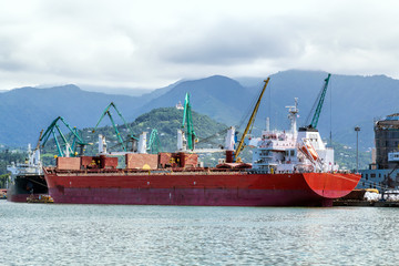 Container ship and fishing boat in the seaport