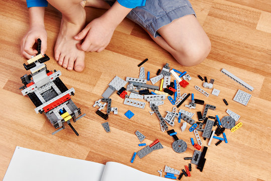 Child collects plastic toy building kit