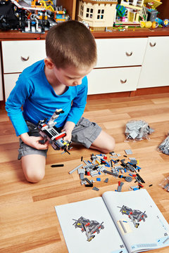 Child collects plastic toy building kit