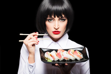 Beautiful woman with sushi rolls