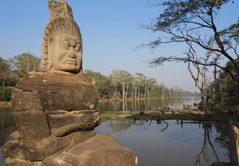 Demon on the Causeway to the South Gate of Angkor Thom showing a part of the enormous 12km  moat around the city built by King Jayavarman VII 1190-1210