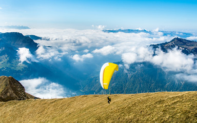 Start of paraglider at Mannlichen top point above Grindelwald, Switzerland.