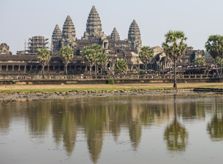 View of  the temples of Angkhor Wat from across a pond in the evening lightt