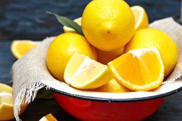 lemons and oranges in an old plate