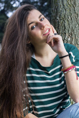 Blue-eyed young model posing in a fashion shoot in the park. 