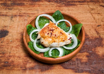 grilled chicken is served in a clay pot