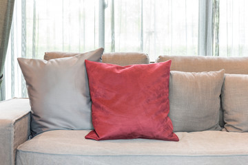 red pillows on modern grey sofa