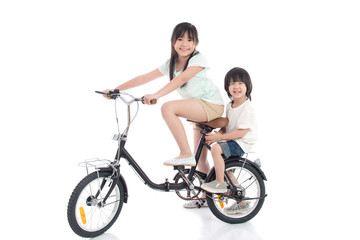 Obraz na płótnie Canvas Asian children riding a bike