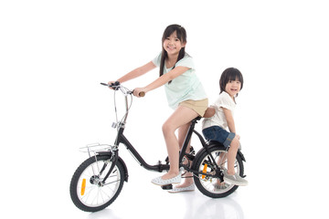 Asian children riding a bike