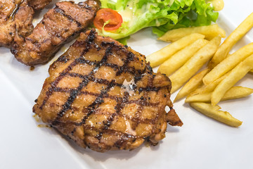 Grilled steak, French fries and vegetables