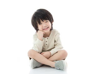 asian boy sitting on white background isolated