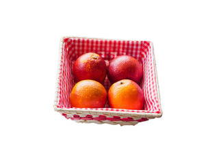 Bunch of red sicilian red oranges in basket isolated on white