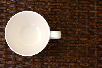 White cup on weave wood table