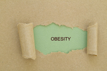 Obesity written under torn paper.