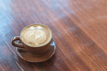 cup of latte coffee on wooden table