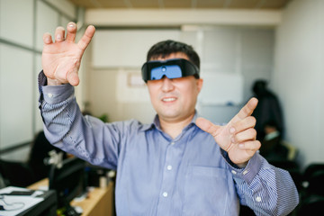 Man with glasses of virtual reality gesturing 