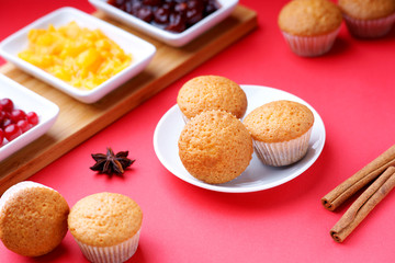Muffins and jam on a red background