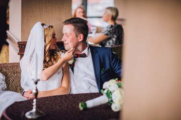 Happy bride and groom in royal vintage interior of restaurant
