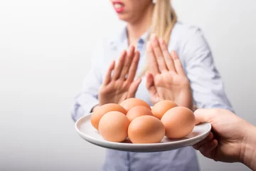 Deurstickers Woman refusing to eat eggs © Kaspars Grinvalds