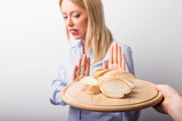Woman refusing to eat bread - obrazy, fototapety, plakaty