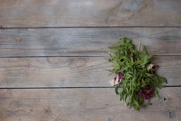 fresh rocket salad on wooden table