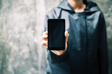 Girl holding black smartphone