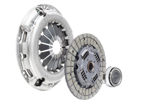 A new set of replacement automotive clutch on a white background. Disc and clutch basket with release bearing
