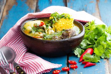Latin american food. Cazuela - traditional chilean soup served in clay plate from pomaire