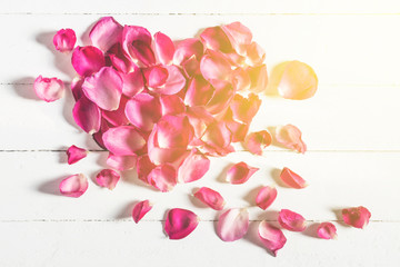 Heart shape of pink rose petals on wood board, Vintage photograp