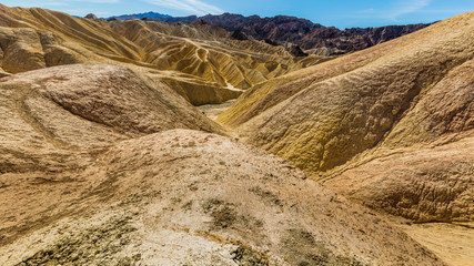 Erosional landscape of hills composed of sediments from Furnace Creek Lake, which dried up 5 million years ago. Wide view of landscape sand dunes. Beautiful view over Zabriskie point, Death Valley