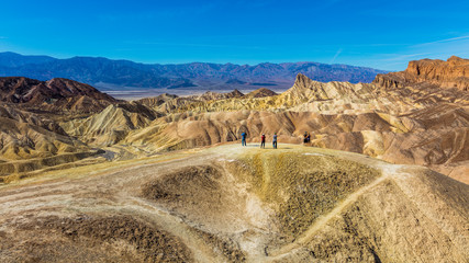 Erosional landscape of hills composed of sediments from Furnace Creek Lake, which dried up 5 million years ago. Wide view of landscape sand dunes. Beautiful view over Zabriskie point, Death Valley
