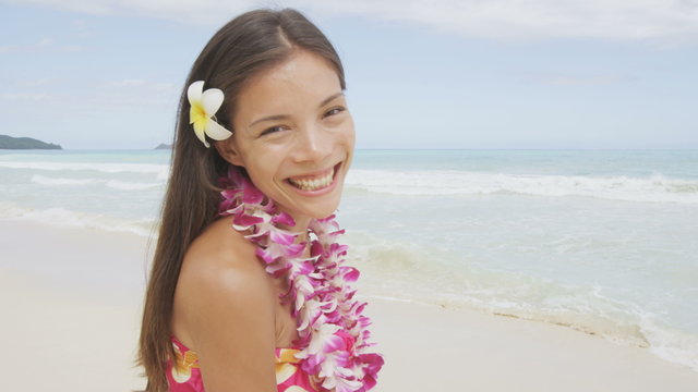 Beach woman smiling happy in sarong - in joyful bliss on travel vacation. Pretty mixed race Asian Caucasian woman on Hawaiian beach resort. Hawaii, USA. RED EPIC SLOW MOTION.