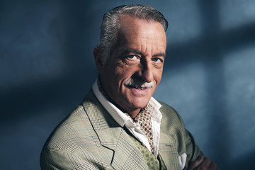 Retro 1940 senior business man. Little smile. Studio shot.