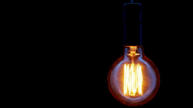 Vintage filament Edison light bulb. Close up. 4K UHD video.
