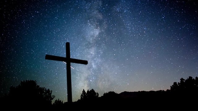 Milky Way stars moving behind a cross