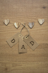 Hearts and cards on wooden table.