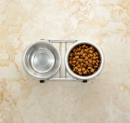 dog food in a metal bowl. water and dry food.