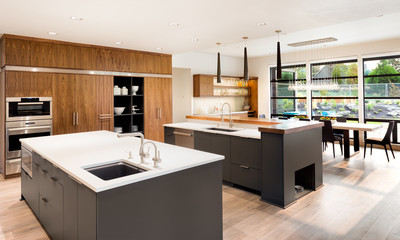 Kitchen in New Luxury Home with Two Islands, Two Sinks, Hardwood Floors, Elegant Cabinetry, Open Floor Plan with View of Dining Room and Outdoor Patio