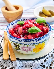 Vegetable salad of cooked beets, carrots and green peas, beans, onions and olive oil.