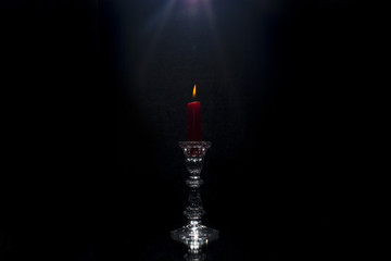 Red candle on black  background 