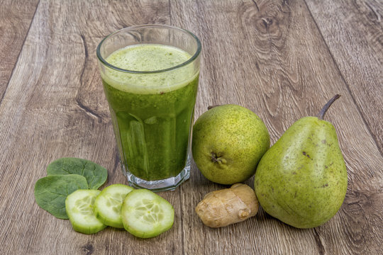 Blended smoothie with ingredients on wooden table