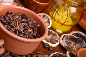 orange and lemon, coffee beans and cinnamon on wooden brown background.