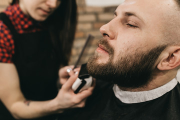 Bearded hipster client visiting barber shop 