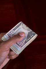 Hand full of money 50 Dollar Bill on Top