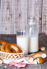 Milk and bagels on a wooden table