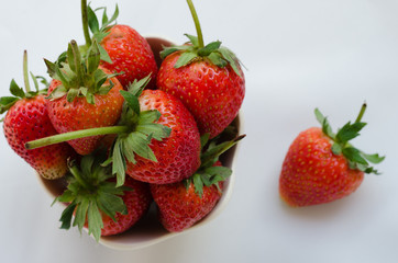 Fresh Strawberries In Bowl On White Fabric Background.