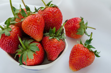 Fresh Strawberries In Bowl On White Fabric Background.